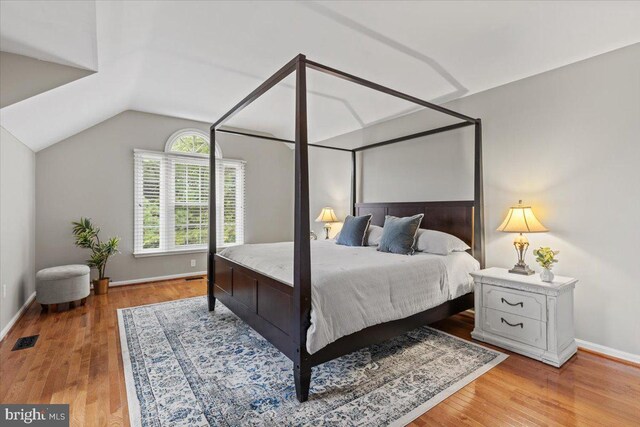 1301 Kelly Ct, Herndon, VA 20170 - bedroom with wood finished floors, lofted ceiling, and baseboards