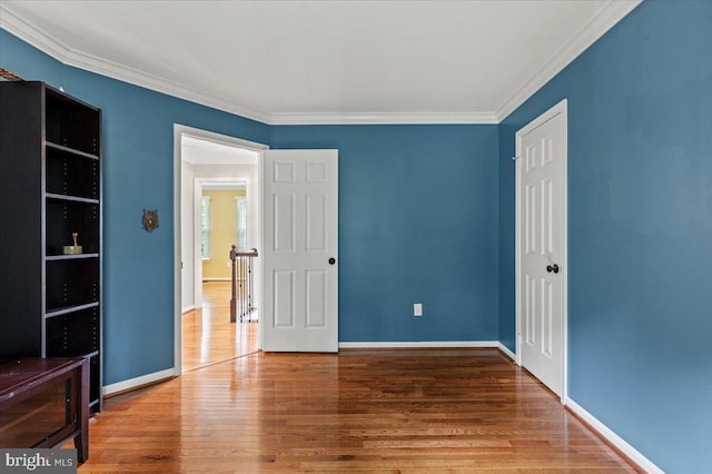1301 Kelly Ct, Herndon, VA 20170 - unfurnished bedroom with wood finished floors, crown molding, baseboards, and a closet