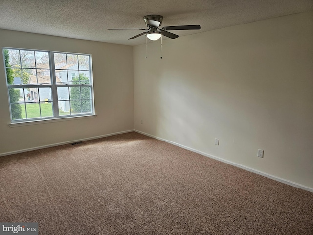 unfurnished room featuring carpet floors, a ceiling fan, and a textured ceiling