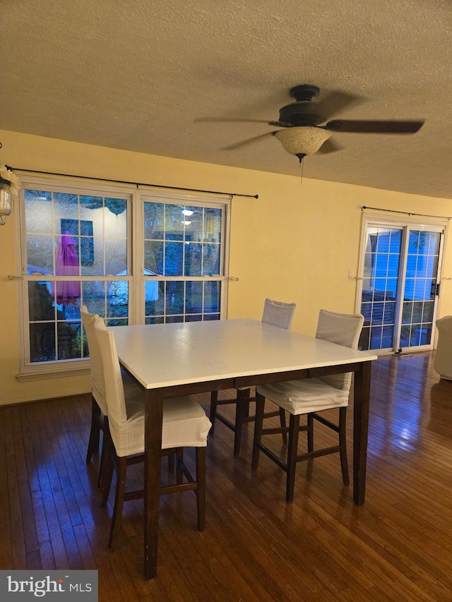 dining area with a ceiling fan, a textured ceiling, and hardwood / wood-style flooring