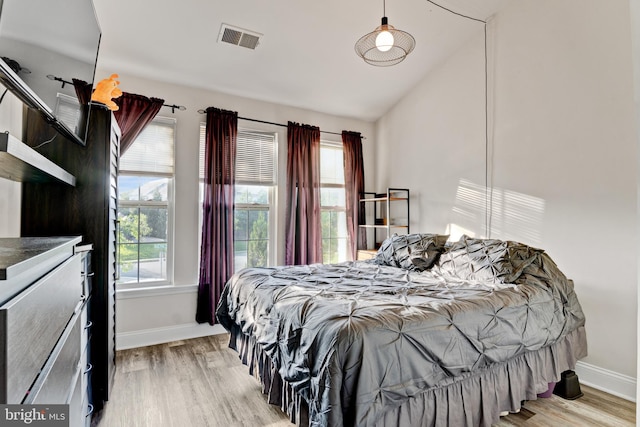 bedroom featuring light wood-style floors, baseboards, and visible vents