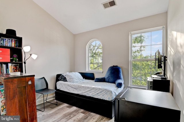 bedroom featuring wood finished floors and visible vents