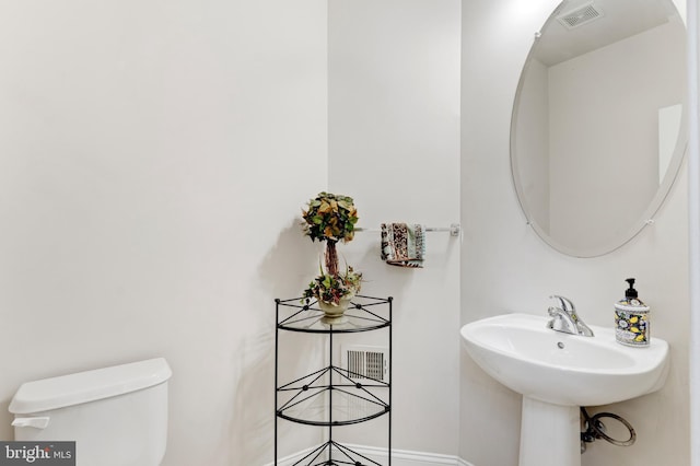 half bath with toilet and visible vents