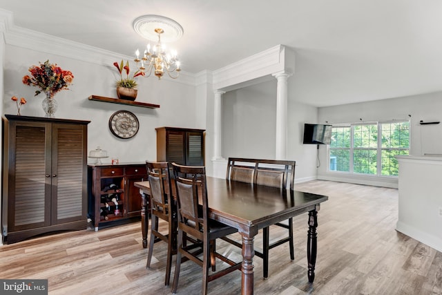 dining space featuring ornamental molding, decorative columns, baseboards, light wood-type flooring, and a chandelier