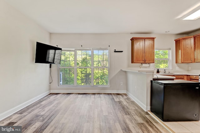 kitchen with brown cabinets, baseboards, and light wood finished floors