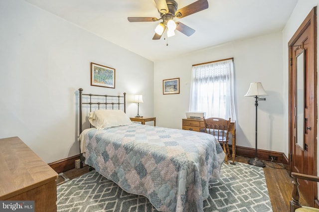bedroom with baseboards, dark wood finished floors, and ceiling fan