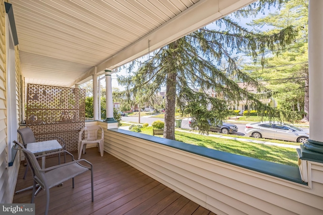wooden terrace with a porch