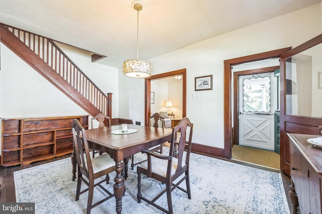 dining room with stairway and baseboards