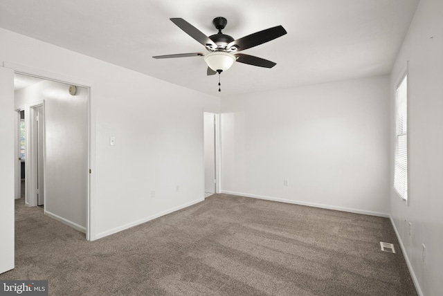 unfurnished room featuring visible vents, carpet, and a healthy amount of sunlight