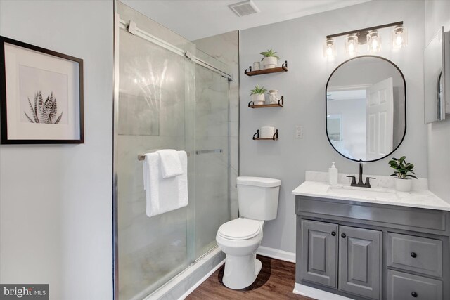 6608 Eaglewing Ln, Fort Washington, MD 20744 - bathroom with toilet, a stall shower, vanity, wood finished floors, and baseboards