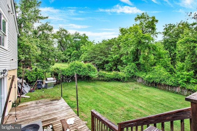 6608 Eaglewing Ln, Fort Washington, MD 20744 - view of yard featuring a wooden deck and view of wooded area