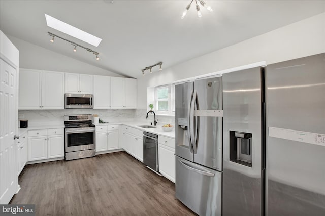 6608 Eaglewing Ln, Fort Washington, MD 20744 - kitchen featuring stainless steel appliances, a skylight, vaulted ceiling, track lighting, and a sink