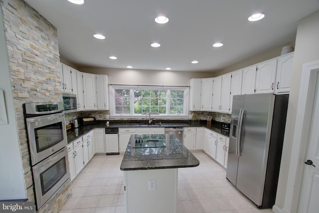 9724 Middleton Ridge Rd, Vienna, VA 22182 - kitchen with tasteful backsplash, appliances with stainless steel finishes, a sink, and a kitchen island