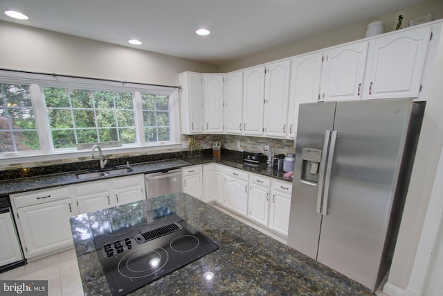 9724 Middleton Ridge Rd, Vienna, VA 22182 - kitchen featuring stainless steel appliances, white cabinets, a sink, and dark stone counters