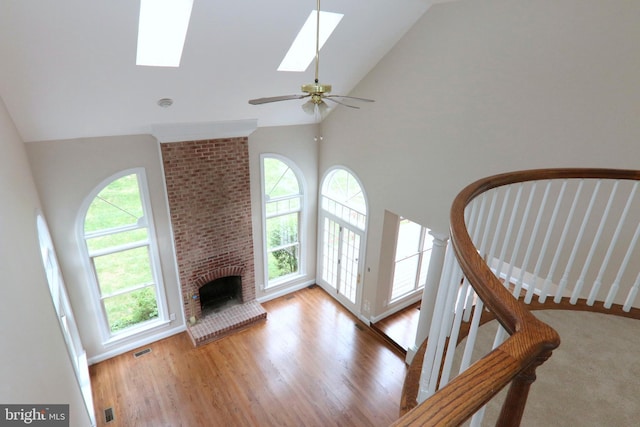 9724 Middleton Ridge Rd, Vienna, VA 22182 - unfurnished living room with a skylight, high vaulted ceiling, visible vents, and wood finished floors