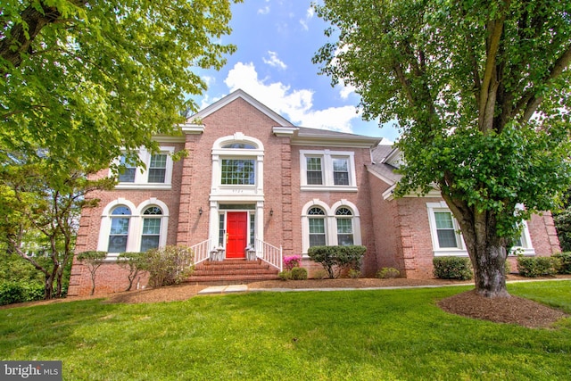 9724 Middleton Ridge Rd, Vienna, VA 22182 - colonial inspired home with a front lawn and brick siding
