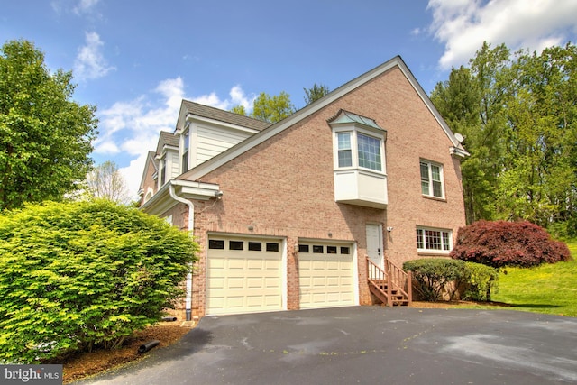 9724 Middleton Ridge Rd, Vienna, VA 22182 - view of side of property featuring an attached garage, brick siding, and driveway
