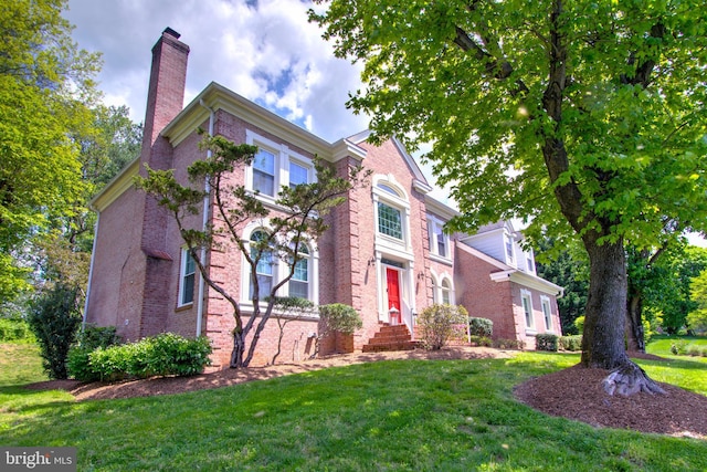 9724 Middleton Ridge Rd, Vienna, VA 22182 - view of front of property featuring a front lawn, brick siding, and a chimney
