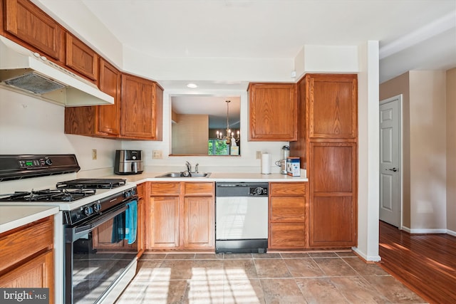 10048 Quiet Brook Ln, Clinton, MD 20735 - kitchen with under cabinet range hood, a sink, dishwashing machine, gas range, and a chandelier