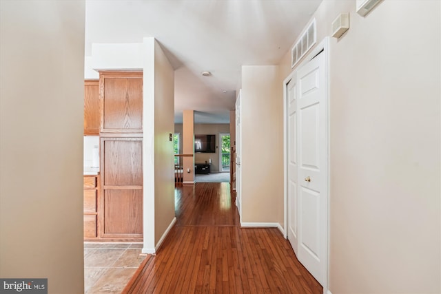 10048 Quiet Brook Ln, Clinton, MD 20735 - corridor featuring baseboards, wood-type flooring, and visible vents