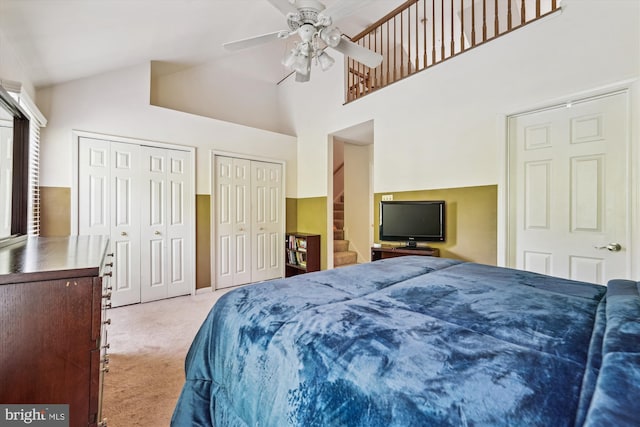 10048 Quiet Brook Ln, Clinton, MD 20735 - carpeted bedroom with two closets, a ceiling fan, and high vaulted ceiling