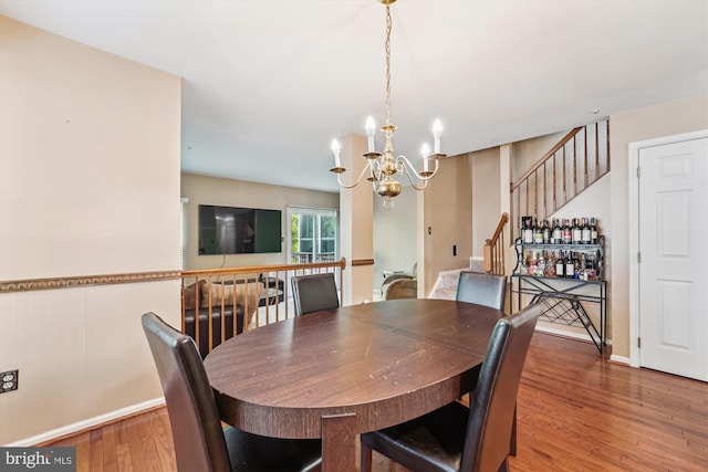 10048 Quiet Brook Ln, Clinton, MD 20735 - dining area with stairs, a notable chandelier, baseboards, and wood finished floors