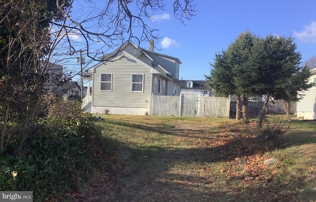 view of side of home with fence