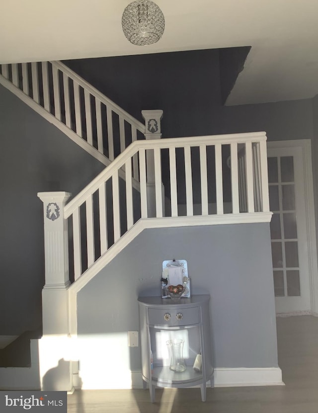 staircase with wood finished floors