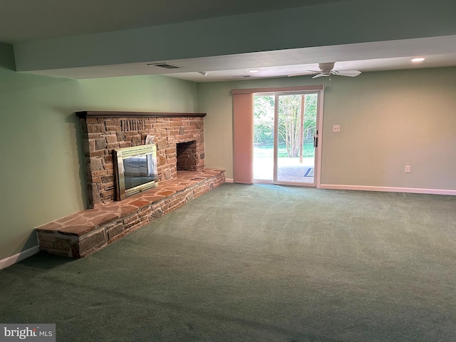 unfurnished living room featuring ceiling fan, a fireplace, carpet floors, baseboards, and visible vents