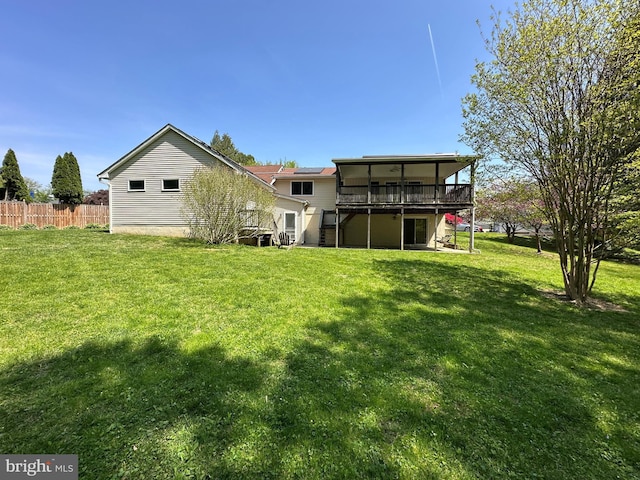 back of property featuring stairway, fence, a yard, and a deck