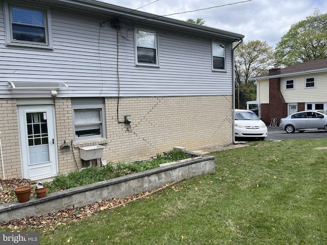 7757 Green Valley Rd, Wyncote, PA 19095 - view of home's exterior featuring brick siding and a yard