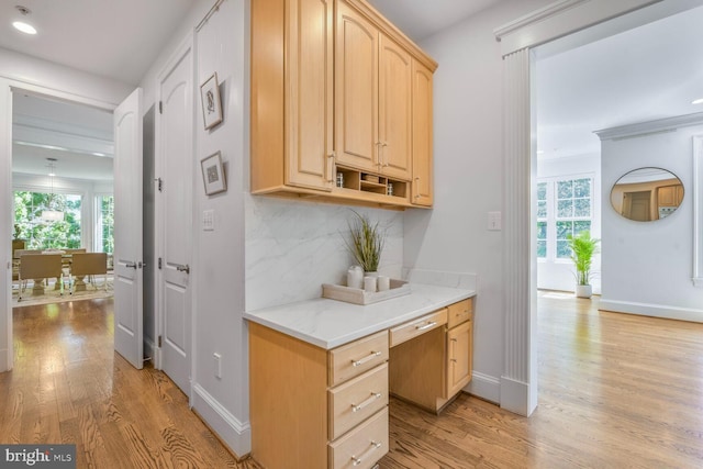 hall with light wood-type flooring and baseboards