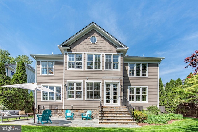 rear view of house with a patio area, french doors, and entry steps