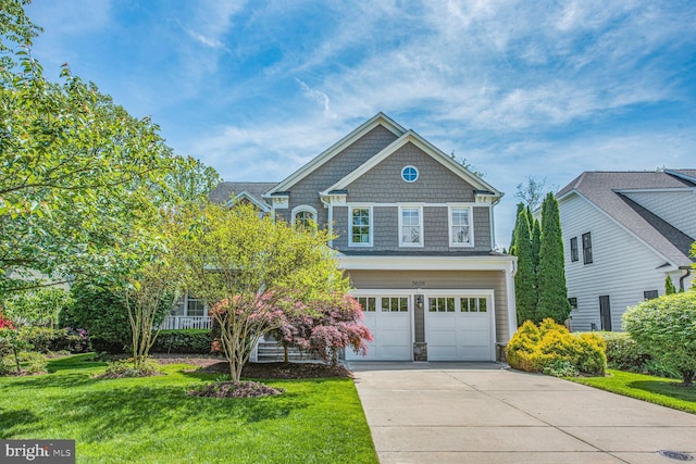 traditional-style home featuring a garage, driveway, and a front yard