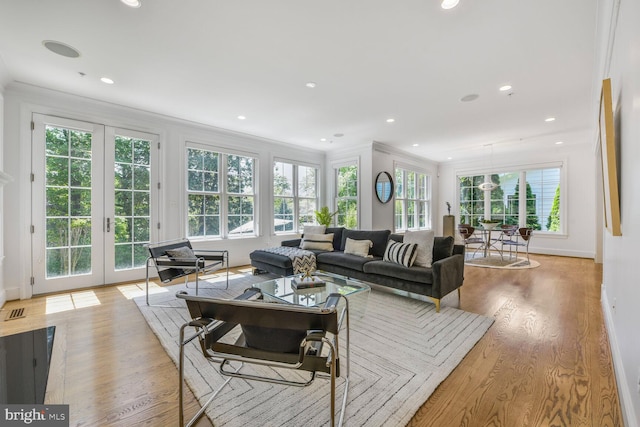 living area with french doors, recessed lighting, crown molding, and wood finished floors