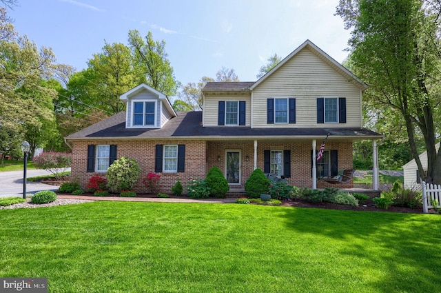 700 Stonecrest Dr, New Holland, PA 17557 - view of front facade with covered porch, a front lawn, and brick siding