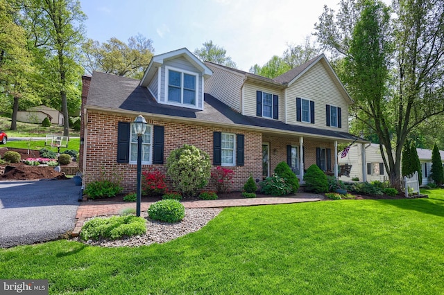 700 Stonecrest Dr, New Holland, PA 17557 - view of front facade featuring brick siding, a front yard, and roof with shingles