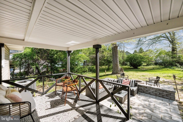 view of patio featuring an outdoor living space with a fire pit