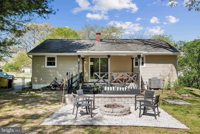 back of house with a patio, a chimney, cooling unit, and a fire pit