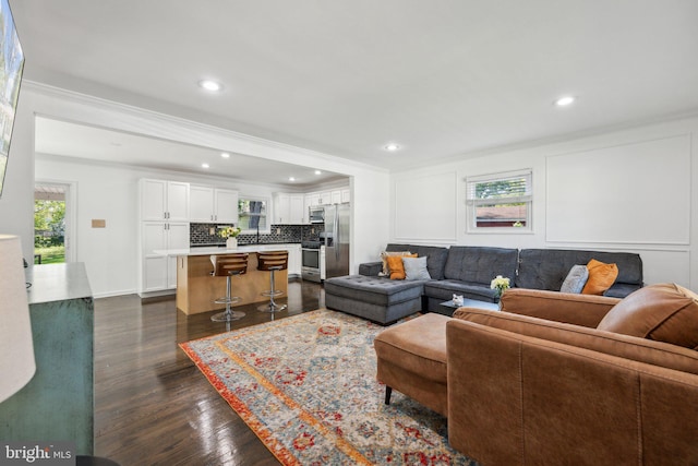 living area with recessed lighting, ornamental molding, and dark wood-style flooring