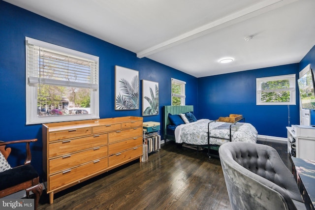 bedroom with baseboards, dark wood-style floors, and beamed ceiling