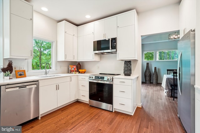 1145 Water Pointe Ln, Reston, VA 20194 - kitchen featuring stainless steel appliances, a sink, light wood-type flooring, healthy amount of natural light, and recessed lighting