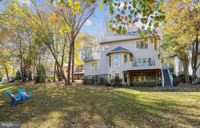 back of house featuring a lawn, stairs, and a deck