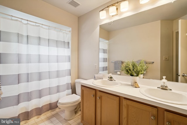 1145 Water Pointe Ln, Reston, VA 20194 - bathroom featuring toilet, double vanity, tile patterned floors, and curtained shower