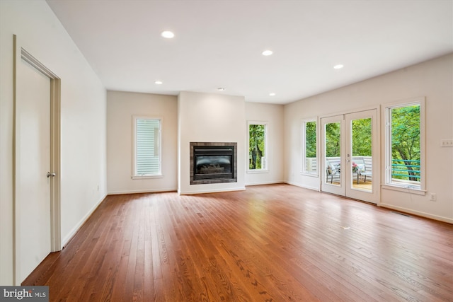 1145 Water Pointe Ln, Reston, VA 20194 - unfurnished living room with hardwood / wood-style flooring, baseboards, a glass covered fireplace, and recessed lighting