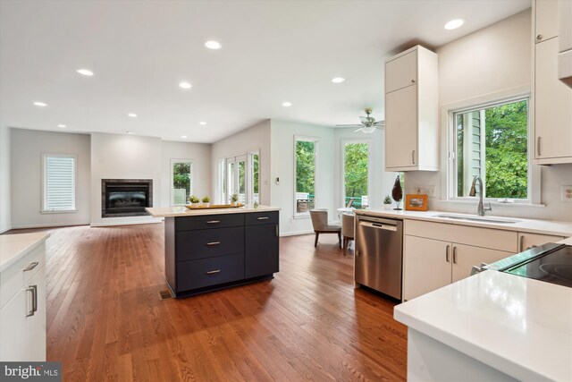 1145 Water Pointe Ln, Reston, VA 20194 - kitchen with dishwasher, a sink, white cabinets, and recessed lighting