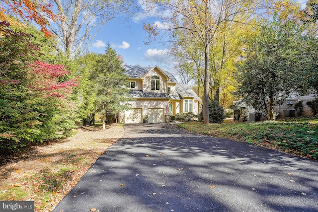 1145 Water Pointe Ln, Reston, VA 20194 - view of front of house with asphalt driveway, a garage, and cooling unit