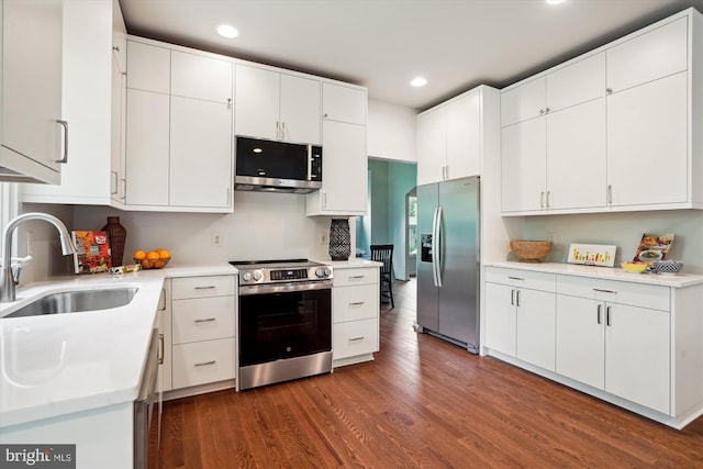 1145 Water Pointe Ln, Reston, VA 20194 - kitchen featuring appliances with stainless steel finishes, a sink, dark wood-style flooring, recessed lighting, and light countertops