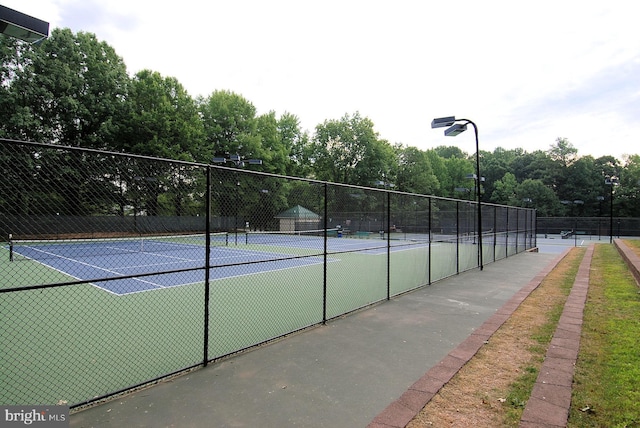 1145 Water Pointe Ln, Reston, VA 20194 - view of tennis court with fence and view of scattered trees