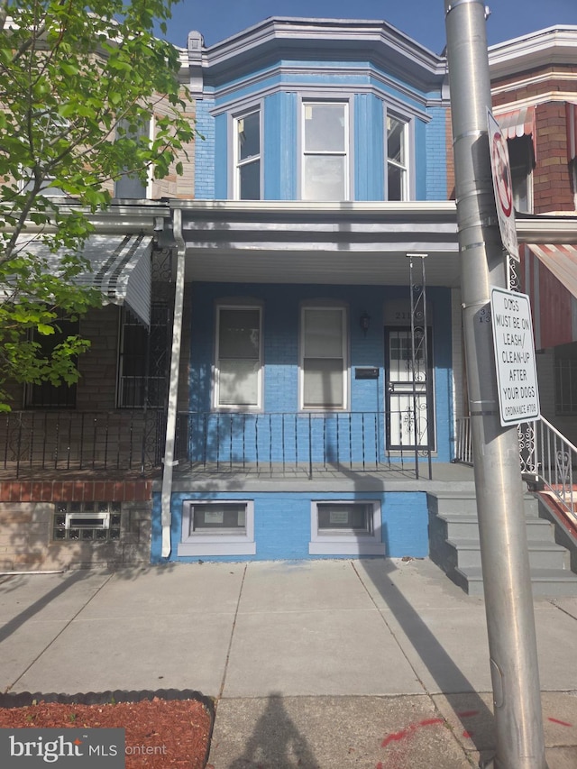 exterior space featuring a porch and brick siding